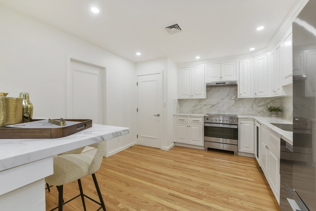 257 Commonwealth Avenue, Unit 2 Boston, MA 02116 - Photo 4 of 10 a kitchen with a stove a sink and a refrigerator