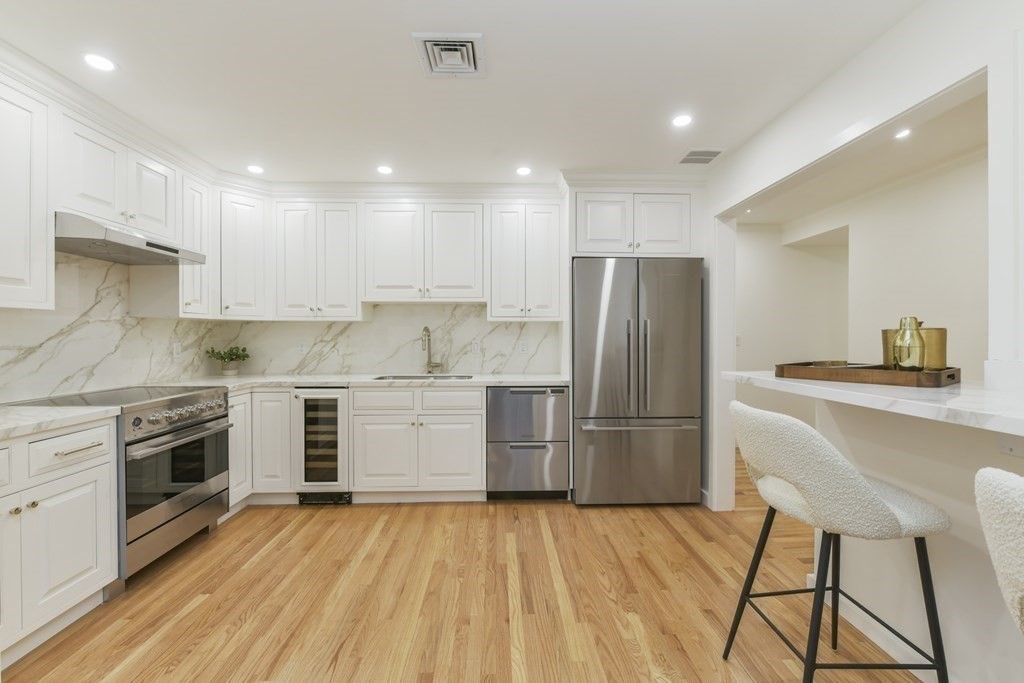 257 Commonwealth Avenue, Unit 2 Boston, MA 02116 - Photo 5 of 10 a kitchen with a stove a refrigerator and a sink