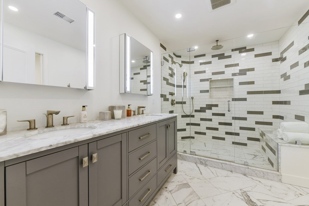 257 Commonwealth Avenue, Unit 2 Boston, MA 02116 - Photo 7 of 10 a bathroom with a granite countertop sink mirror and