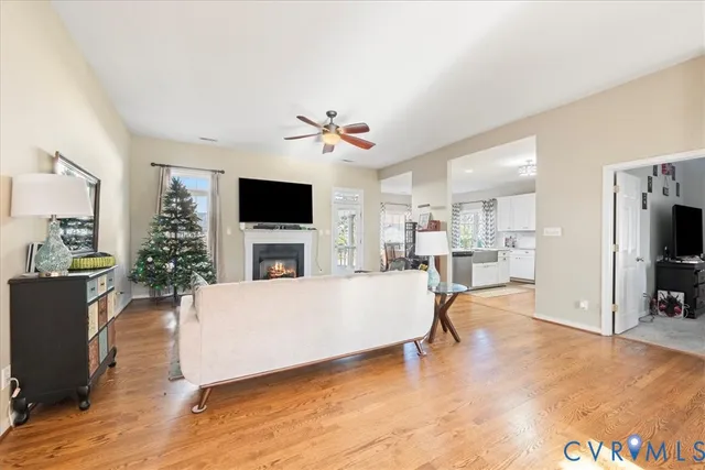 a living room with furniture a flat screen tv and a kitchen view