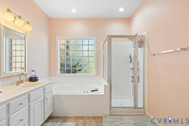 a bathroom with a tub sink and mirror