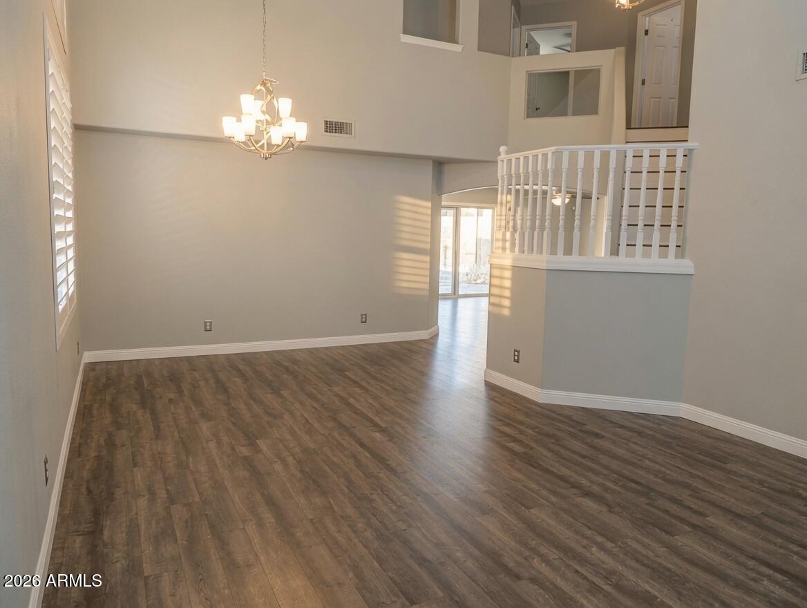 4409 East Dry Creek Road Phoenix, AZ 85044 - Photo 11 of 34 a view of an empty room with wooden floor and a window