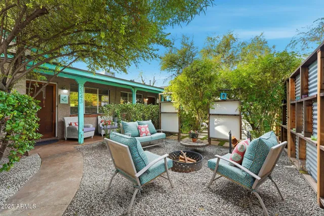 a view of a house with backyard porch and sitting area