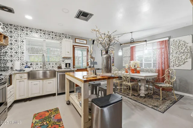 a living room with furniture fireplace and a large window