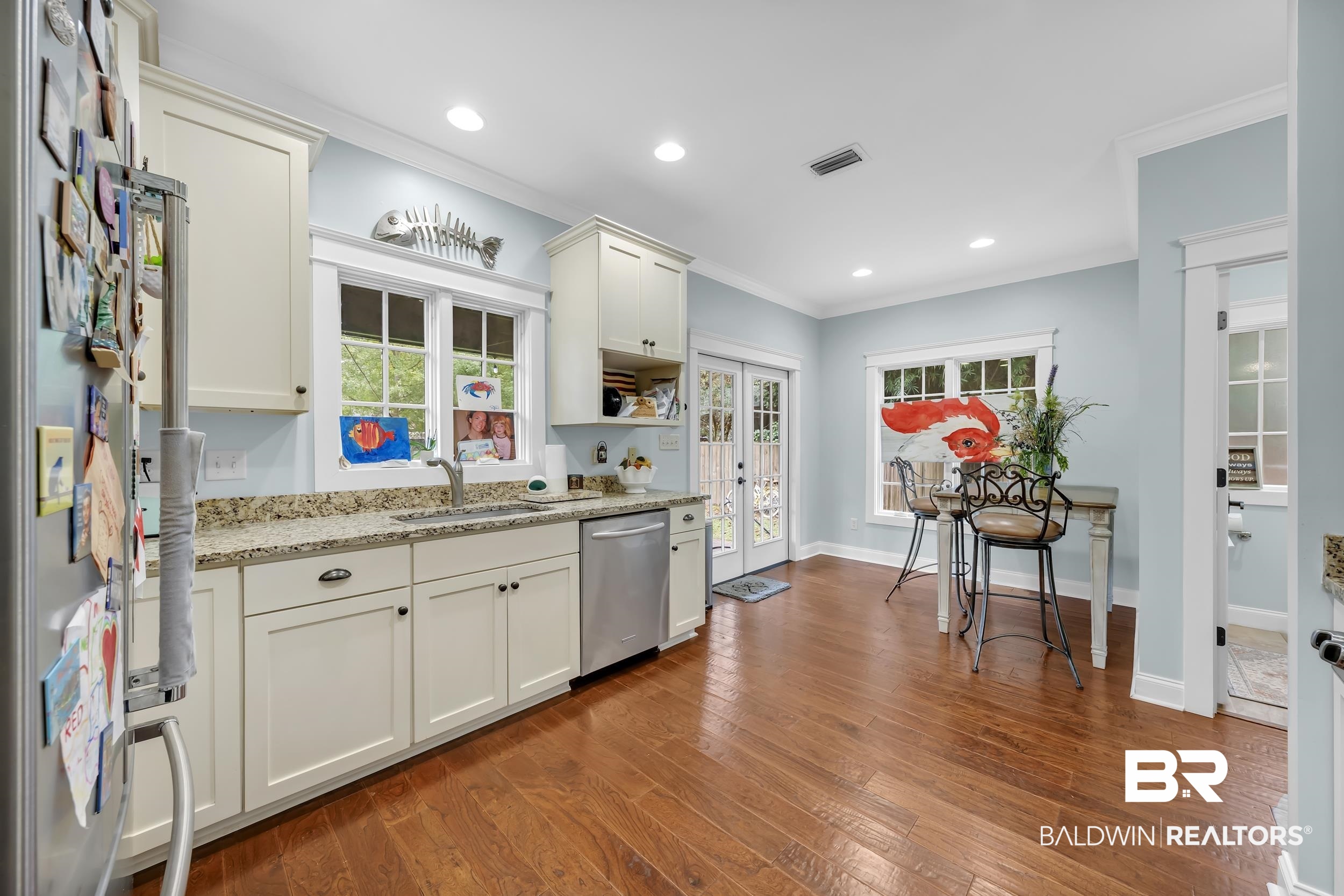 7 Bienville Avenue Mobile, AL 36606 - Photo 12 of 32 Kitchen with light stone counters, stainless steel appliances, crown molding, dark wood-style floors, and recessed lighting