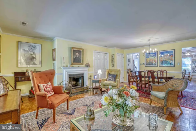 a living room with furniture a fireplace and a table