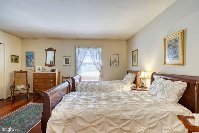 a bedroom with a bed a couch and dresser