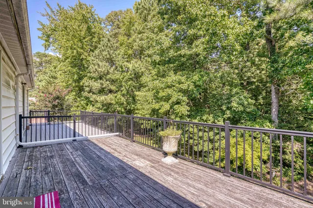 a balcony with wooden floor and chair