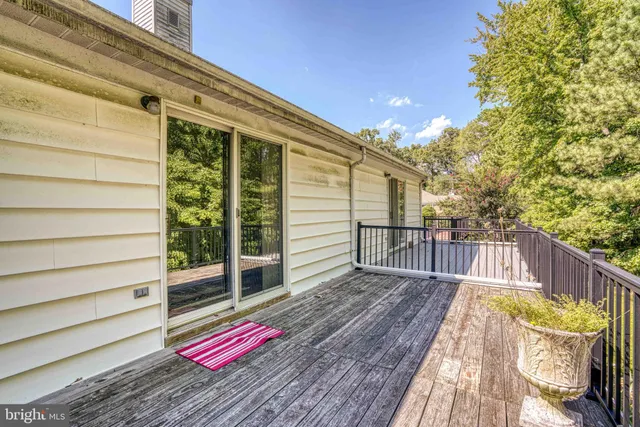 a view of balcony with wooden floor and fence