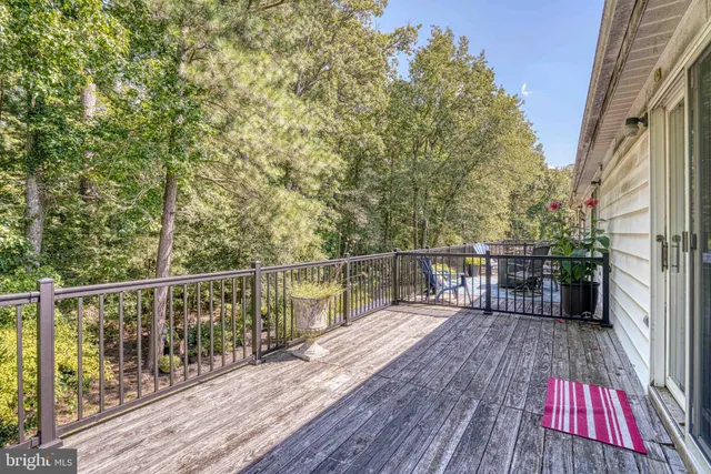 a swimming pool view with a seating space and garden view