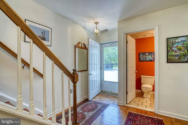 a view of an entryway with wooden floor and door