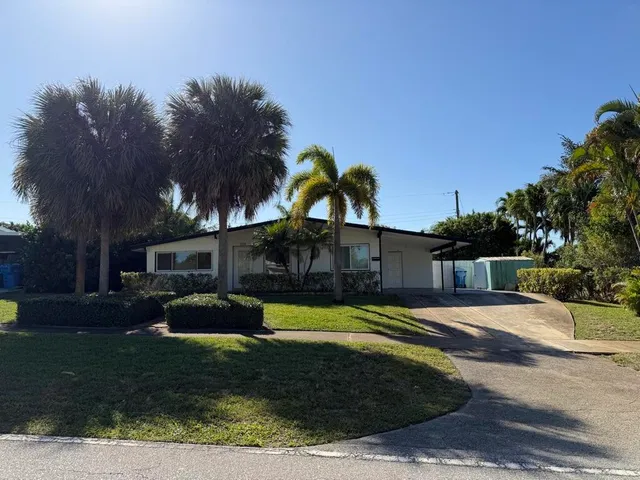 a view of a yard with a house in the background