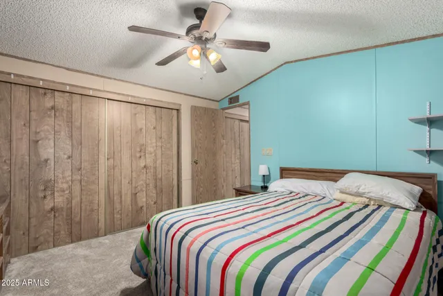 a bedroom with a large bed and a chandelier
