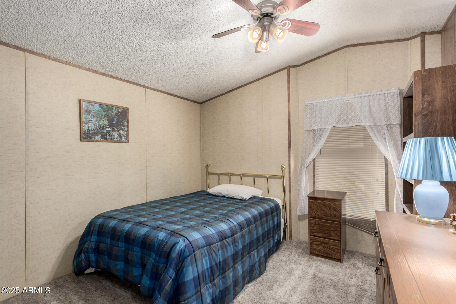 11101 East University Drive, Unit 214 Apache Junction, AZ 85120 - Photo 14 of 30 a bedroom with a bed and a chandelier