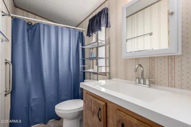 a bathroom with a sink a toilet and a window
