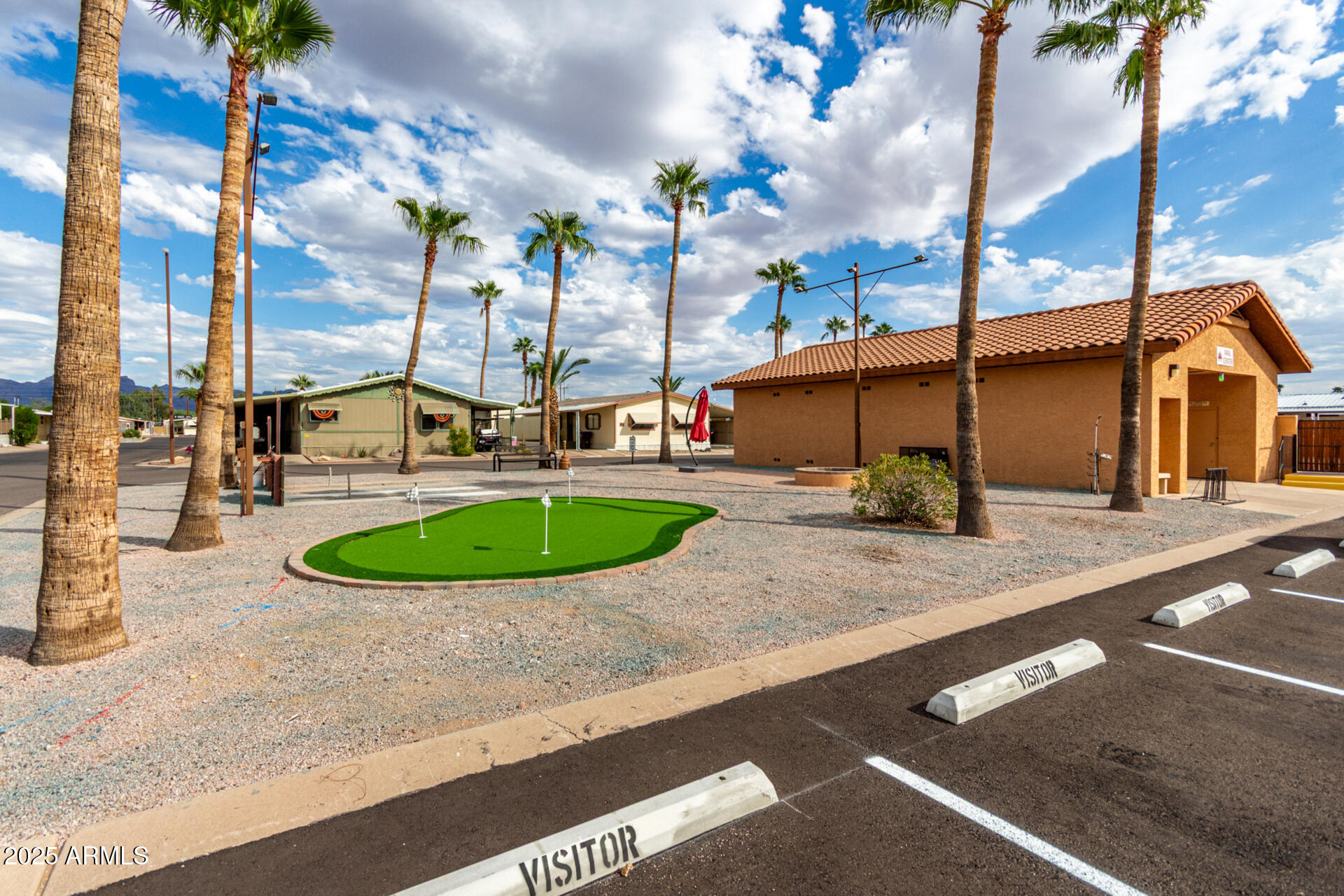 11101 East University Drive, Unit 214 Apache Junction, AZ 85120 - Photo 19 of 30 a view of a house with a backyard porch and sitting area