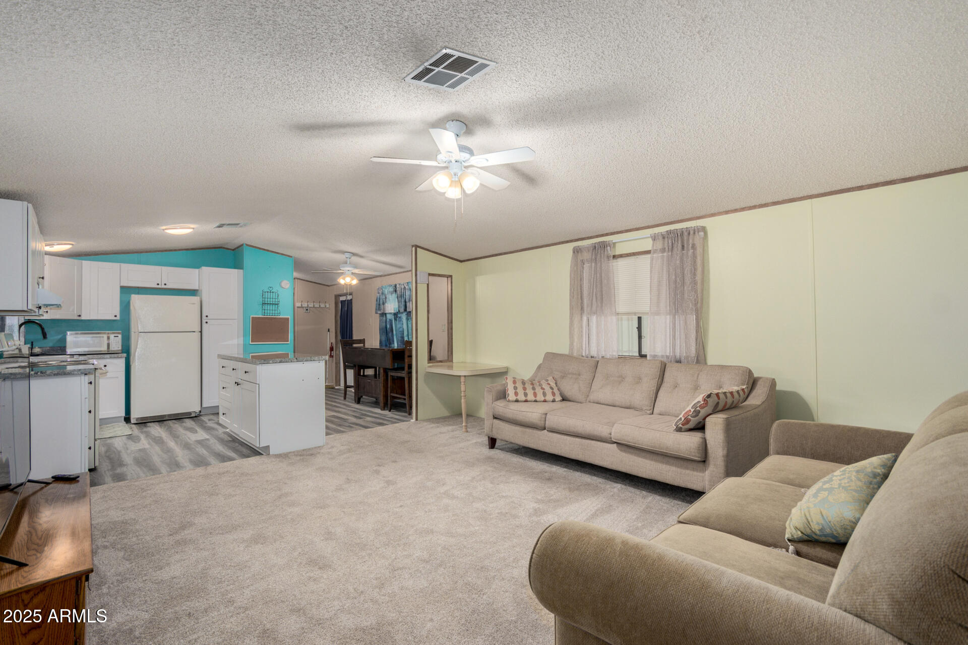 11101 East University Drive, Unit 214 Apache Junction, AZ 85120 - Photo 5 of 30 a living room with furniture and kitchen view