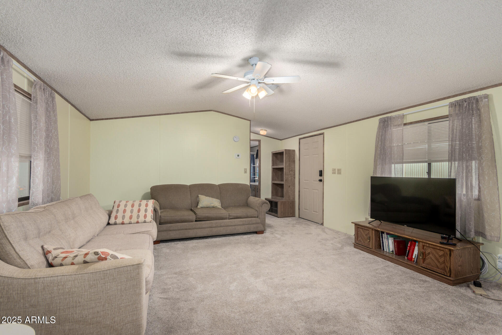 11101 East University Drive, Unit 214 Apache Junction, AZ 85120 - Photo 6 of 30 a living room with furniture and a flat screen tv