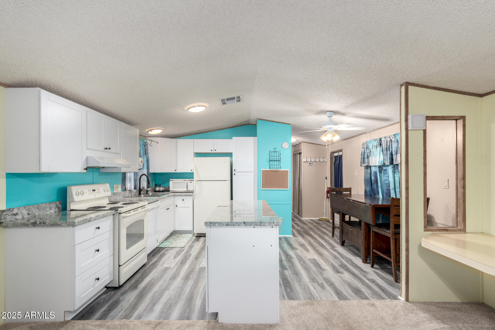 11101 East University Drive, Unit 214 Apache Junction, AZ 85120 - Photo 7 of 30 a large white kitchen with cabinets