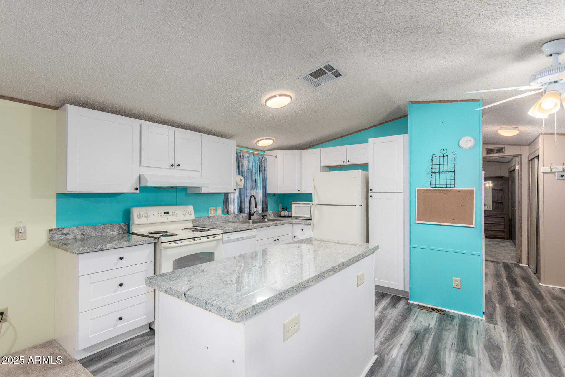 11101 East University Drive, Unit 214 Apache Junction, AZ 85120 - Photo 8 of 30 a kitchen with white cabinets and refrigerator