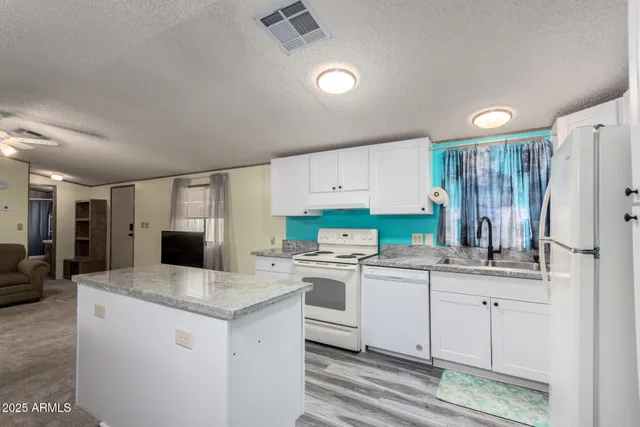 a kitchen with a sink stove and refrigerator