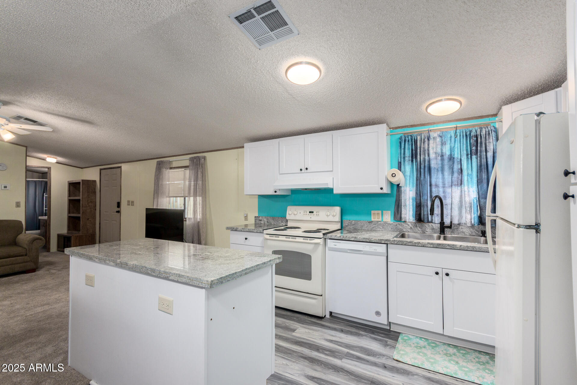 11101 East University Drive, Unit 214 Apache Junction, AZ 85120 - Photo 9 of 30 a kitchen with a sink stove and refrigerator