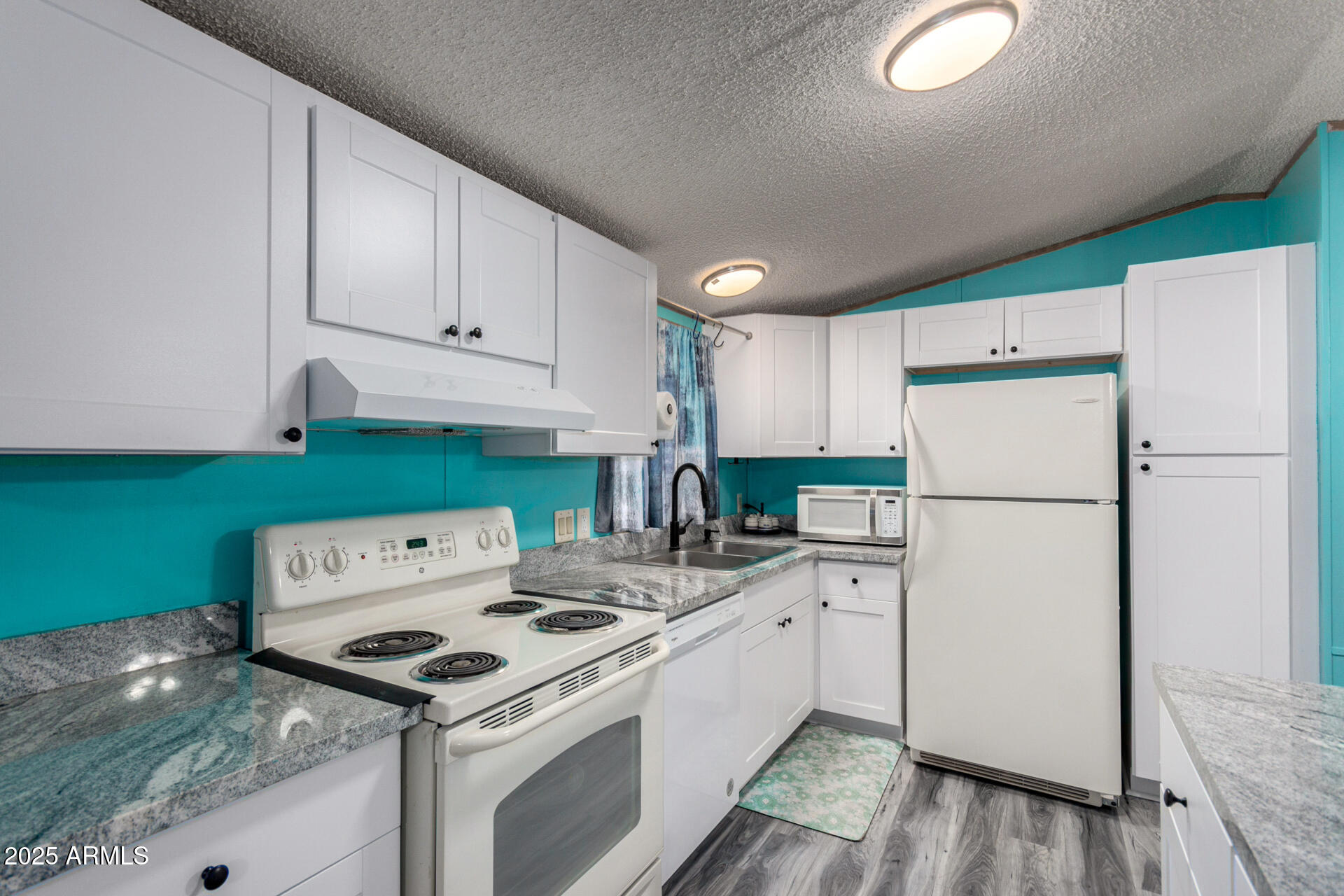 11101 East University Drive, Unit 214 Apache Junction, AZ 85120 - Photo 10 of 30 a kitchen with a stove a refrigerator and a sink