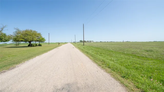 a view of a field with an ocean view