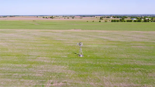 a view of a lake and green valley