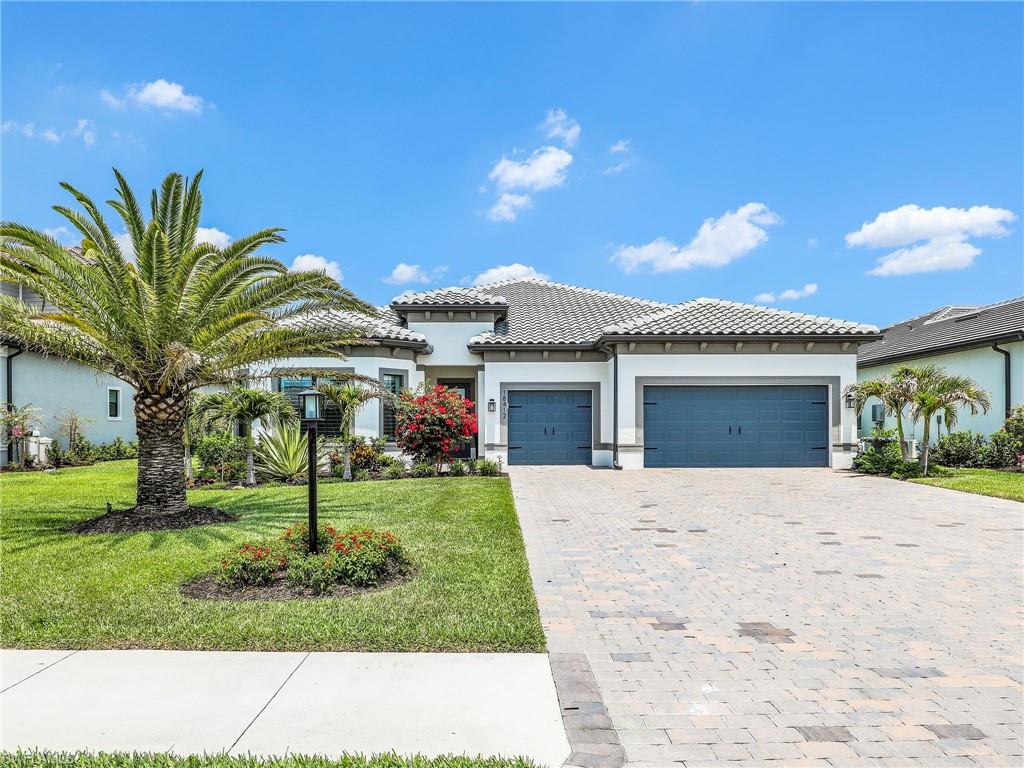 18412 Ridgeline Drive Estero, FL 33928 - Photo 5 of 50 a front view of a house with a yard