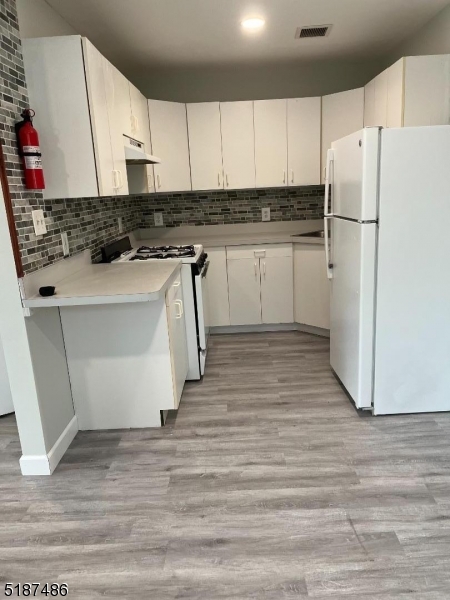 a kitchen with stainless steel appliances a refrigerator sink and cabinets