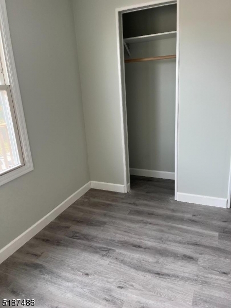 336 Bloomfield Avenue Caldwell, NJ 07006 - Photo 6 of 8 a view of an empty room with wooden floor and a window