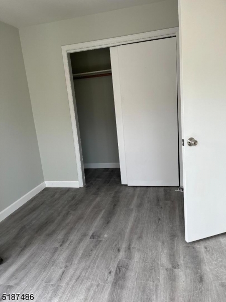 336 Bloomfield Avenue Caldwell, NJ 07006 - Photo 7 of 8 an empty room with wooden floor and closet