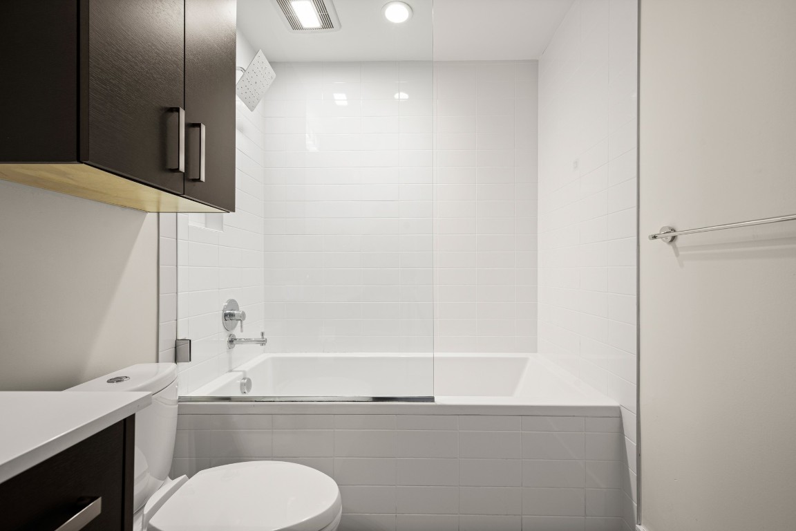 222 West Avenue, Unit 2012 Austin, TX 78701 - Photo 15 of 37 a bathroom with a granite countertop sink mirror vanity and toilet