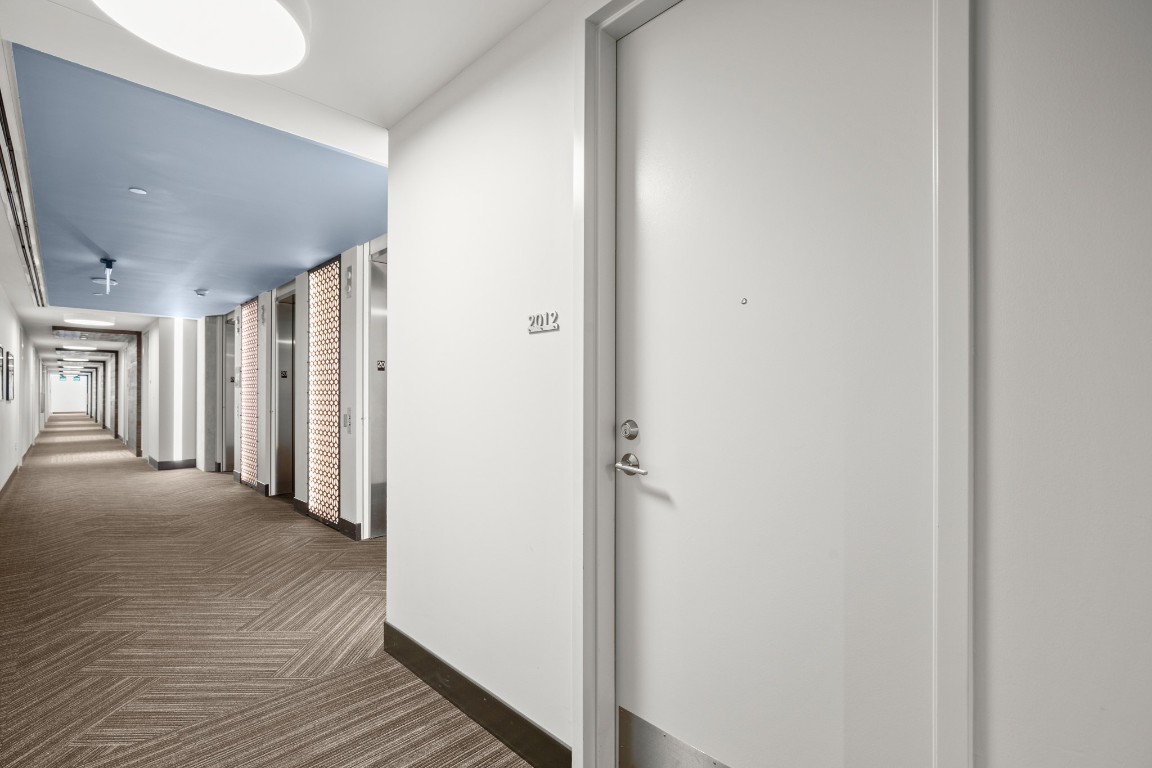 222 West Avenue, Unit 2012 Austin, TX 78701 - Photo 20 of 37 a view of a hallway with wooden floor