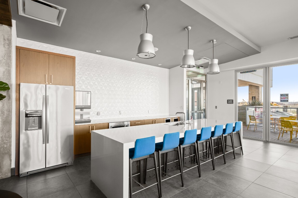222 West Avenue, Unit 2012 Austin, TX 78701 - Photo 27 of 37 a large kitchen with a table and chairs