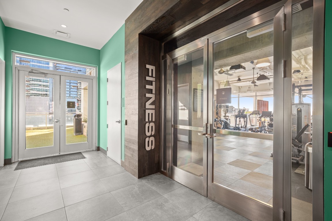 222 West Avenue, Unit 2012 Austin, TX 78701 - Photo 28 of 37 a view of a hallway with wooden floor and a dining room