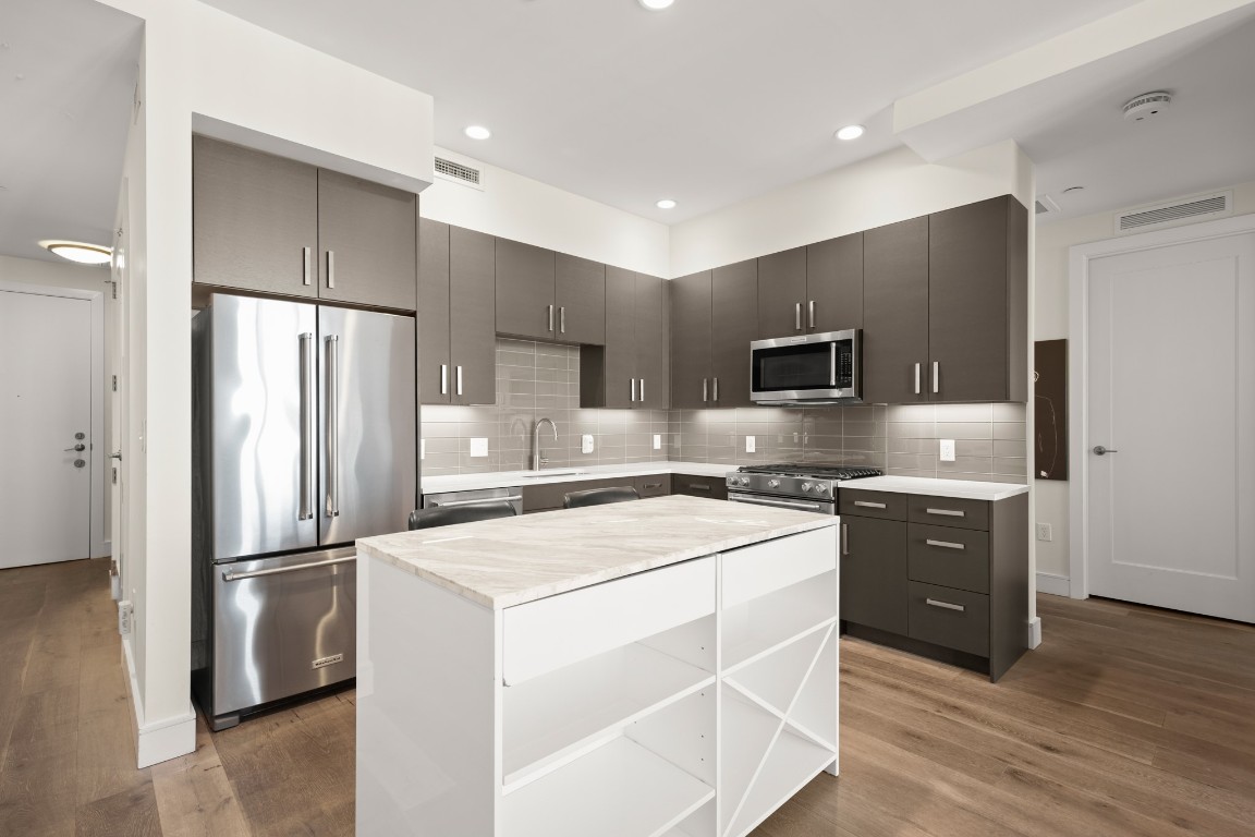 222 West Avenue, Unit 2012 Austin, TX 78701 - Photo 3 of 37 a kitchen with stainless steel appliances a refrigerator sink and microwave