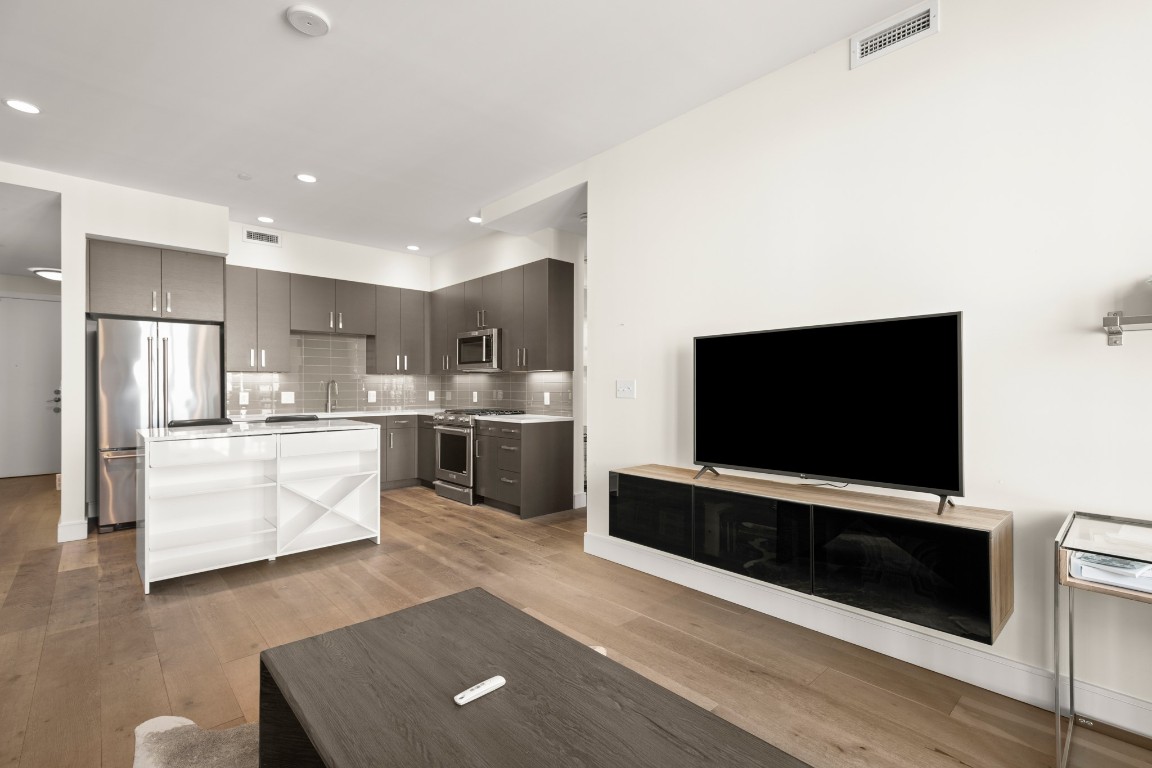 222 West Avenue, Unit 2012 Austin, TX 78701 - Photo 7 of 37 a living room with stainless steel appliances furniture and a flat screen tv