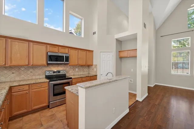 a kitchen with stainless steel appliances a sink dishwasher stove and microwave