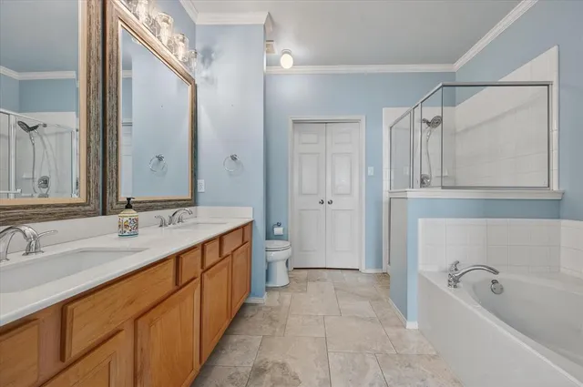 a spacious bathroom with a tub sink and mirror