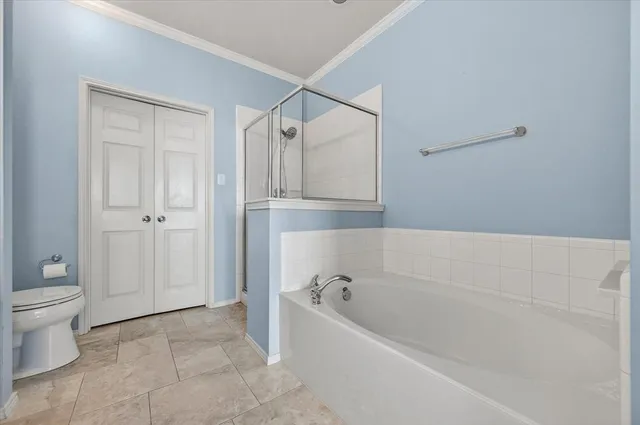 a bathroom with a bathtub and toilet