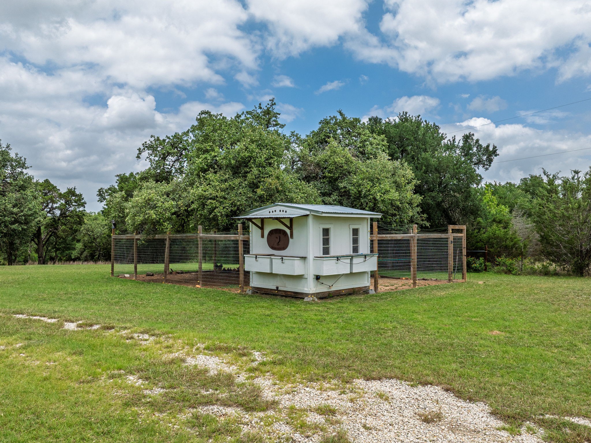 320 Greenridge Road Georgetown, TX 78628 - Photo 35 of 38 a white house with a big yard and big trees with wooden fence