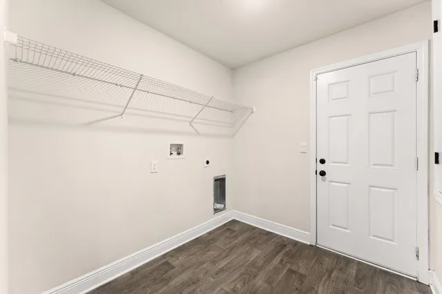 a kitchen with stainless steel appliances granite countertop a sink stove refrigerator and white cabinets with wooden floor