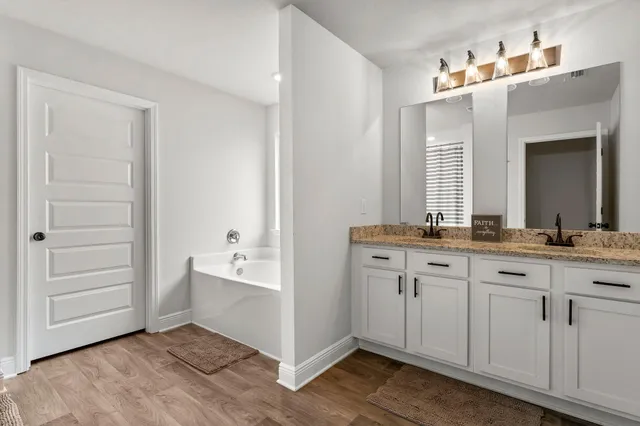 a bathroom with a double vanity sink and a mirror