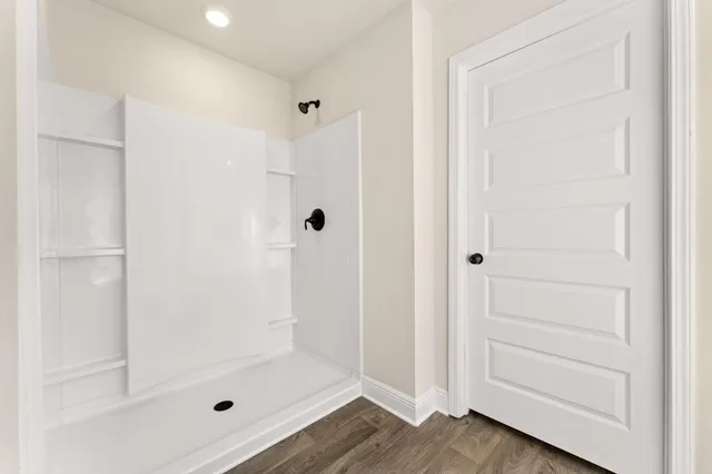 a view of an empty room with wooden floor