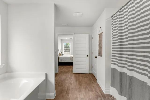 a bathroom with a bathtub and a shower