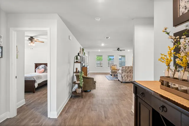a gym room with furniture and a flat screen tv