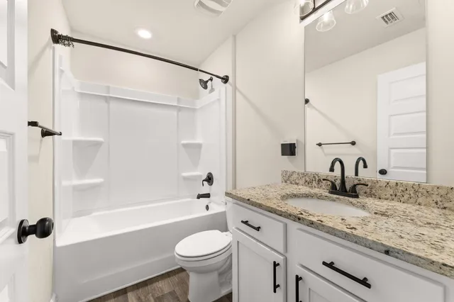a view of room with a ceiling fan and wooden floor