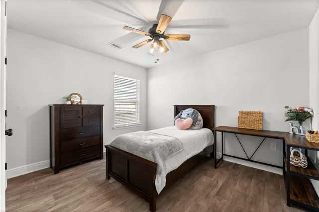 a bedroom with a bed and a dresser